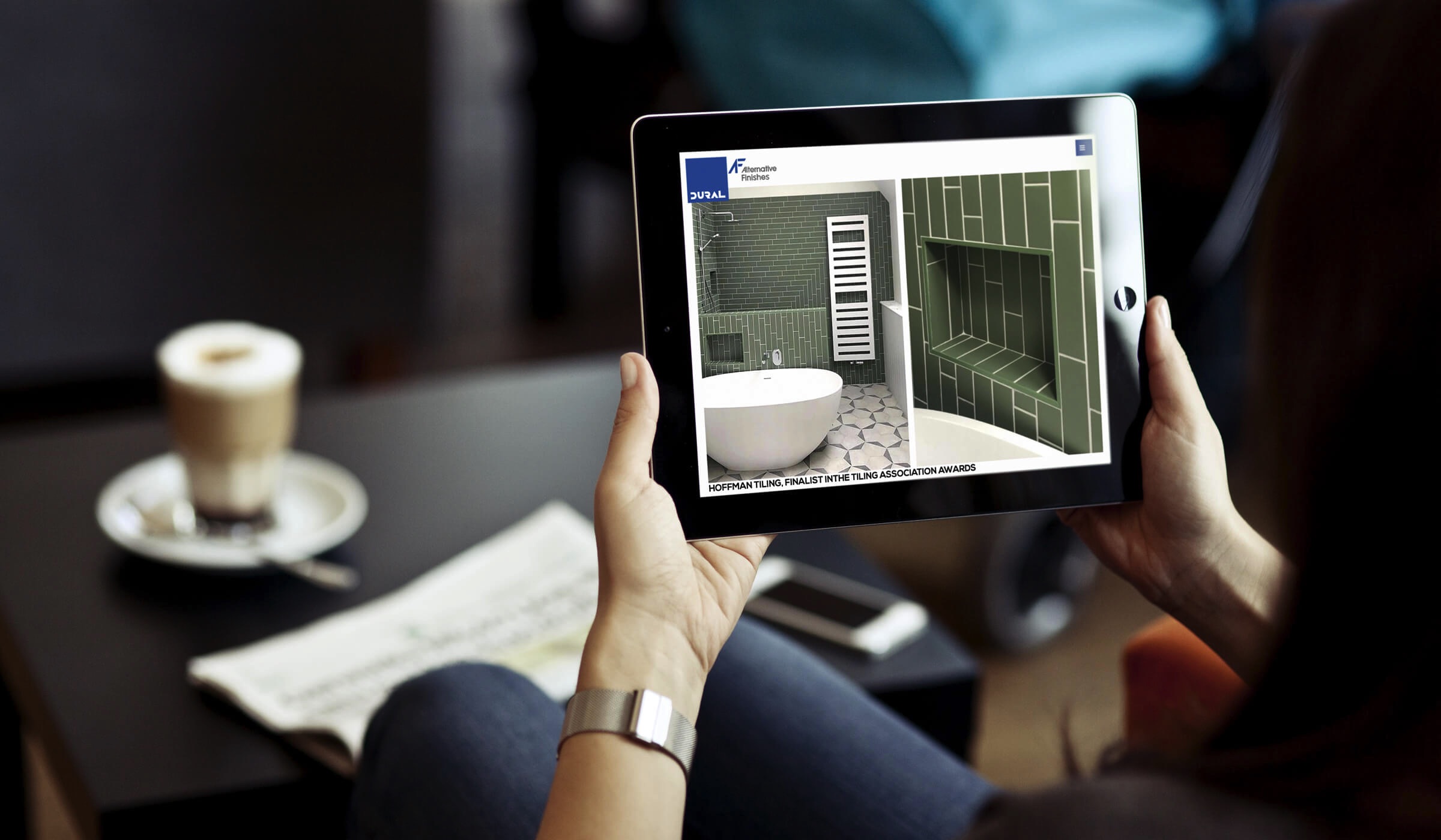 Image of hands holding an iPad that shows the Alternative Finishes blog page